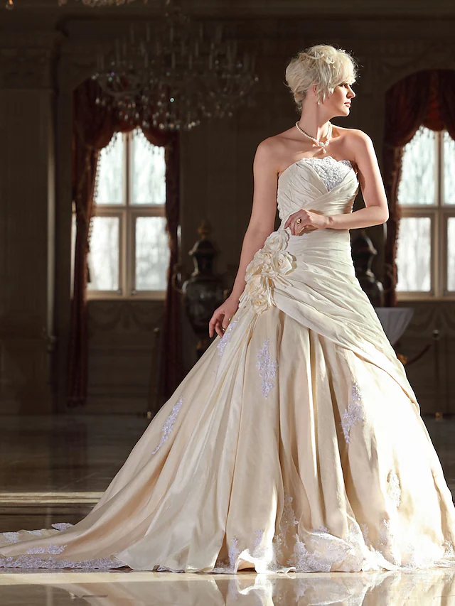 A-Line bridal gown with intricate beaded lace details.