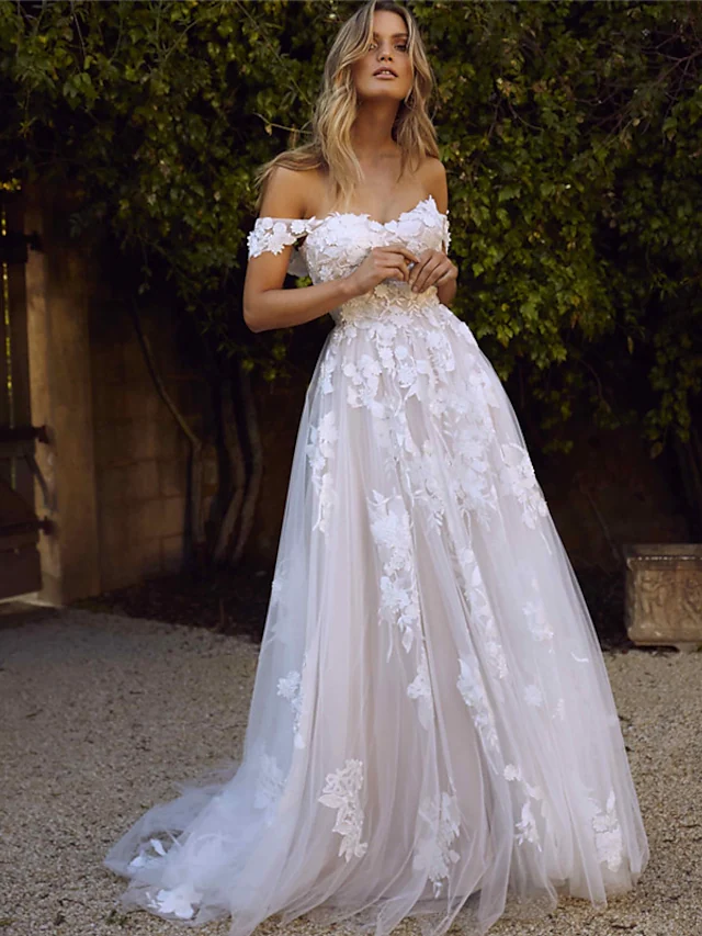 Back view of the A-line wedding dress, highlighting the backless design and intricate lace appliques.