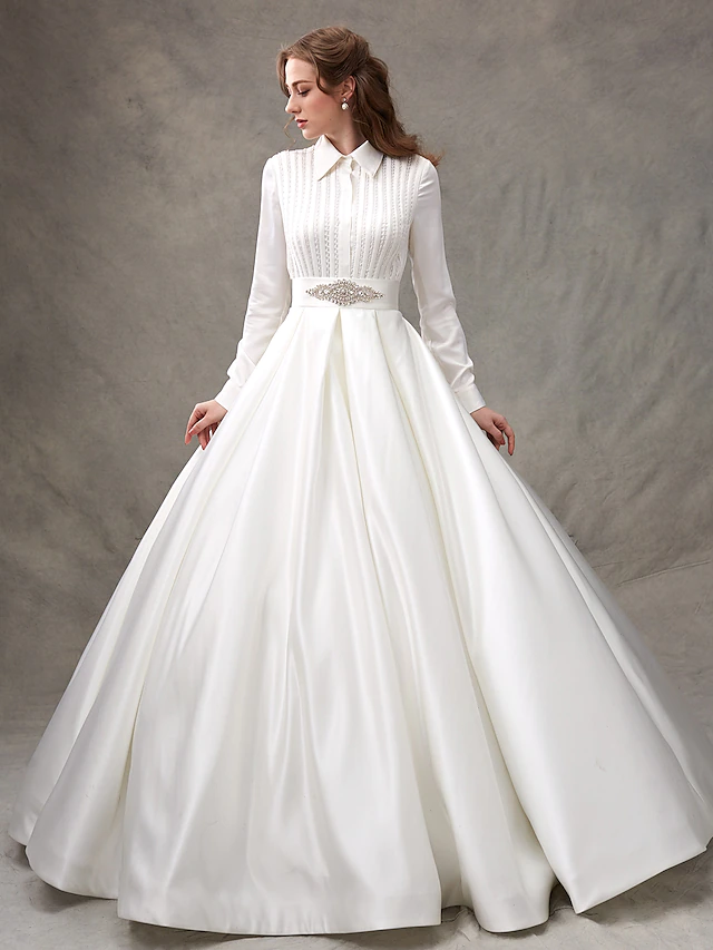 Model wearing a white high-neck long-sleeve satin ball gown wedding dress with a bowknot sash.