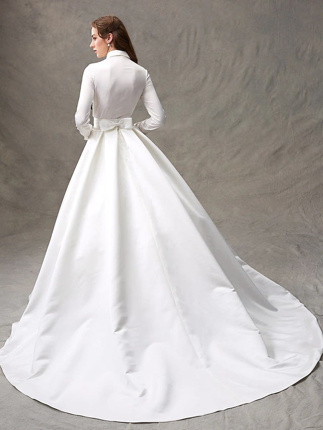 Close-up of the high neck and bodice of the satin wedding dress.