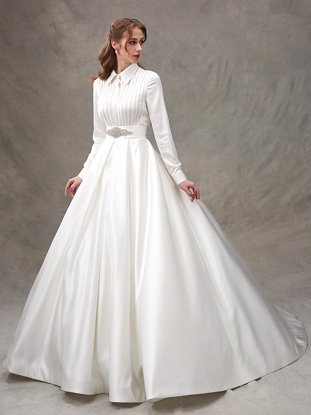 Detail of the sparkling embellishments and ribbon beading on the wedding dress.