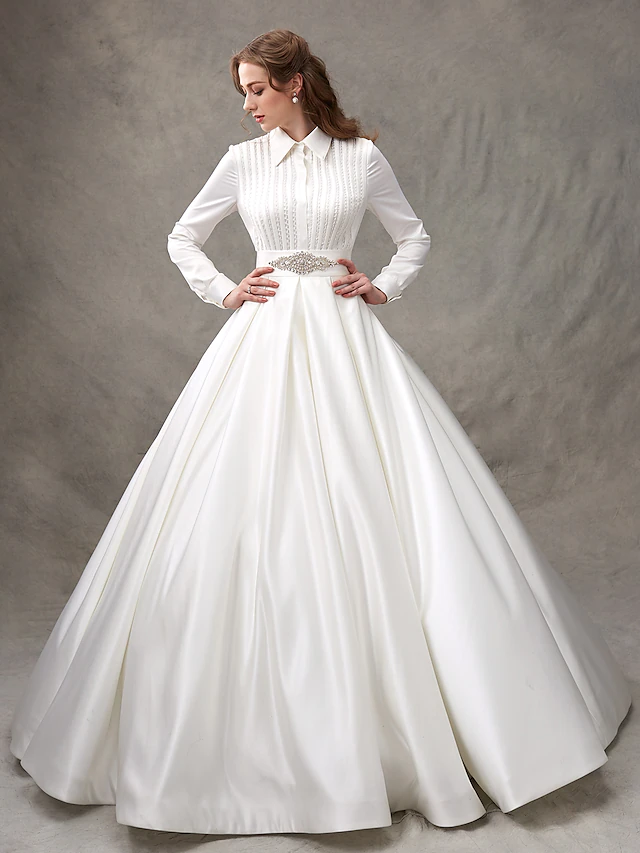 Model posing gracefully in the high-neck long-sleeve wedding gown.