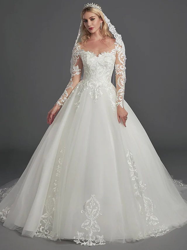 Glamorous ball gown wedding dress with illusion neck and long lace tulle sleeves.