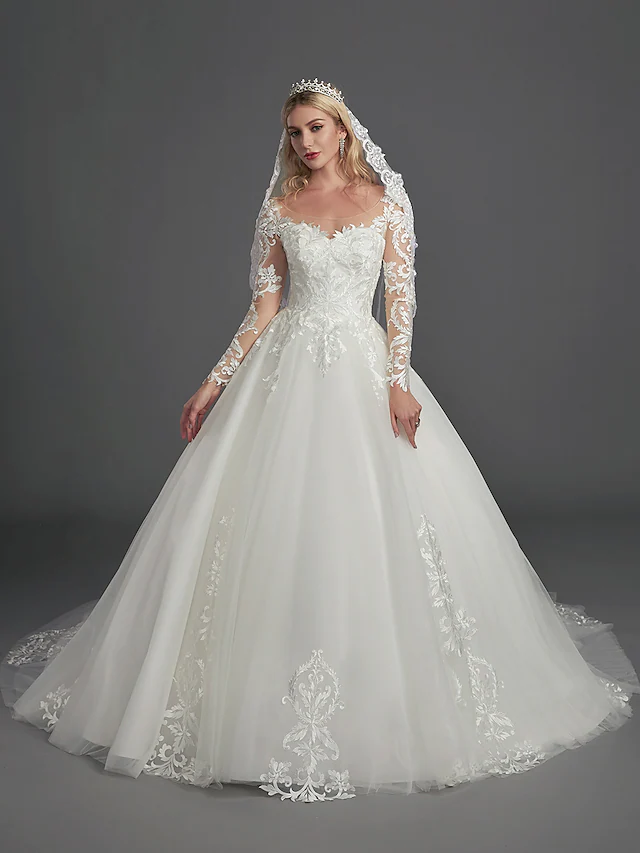 Back view of the ball gown wedding dress, showing the chapel train and button details.