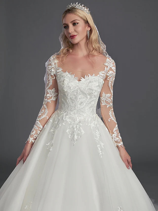 Full length view of the wedding dress, showcasing the flowing tulle skirt.