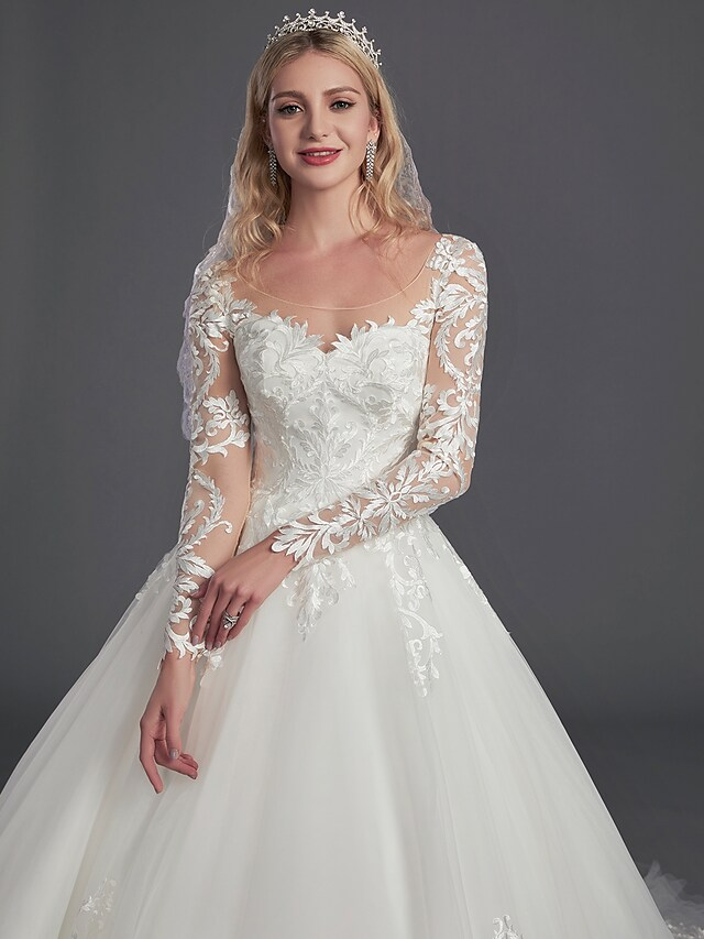 Bride posing gracefully in the glamorous ball gown wedding dress.