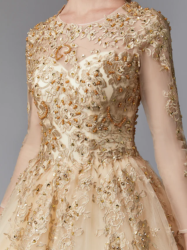 Close-up of the delicate lace pattern on the long sleeves of the bridal gown.