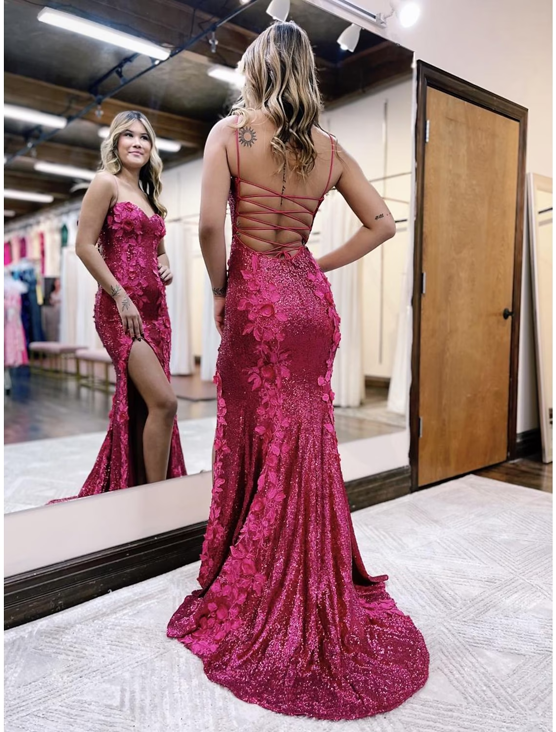 Close-up of the sequined fabric and backless detail of the mermaid trumpet gown.