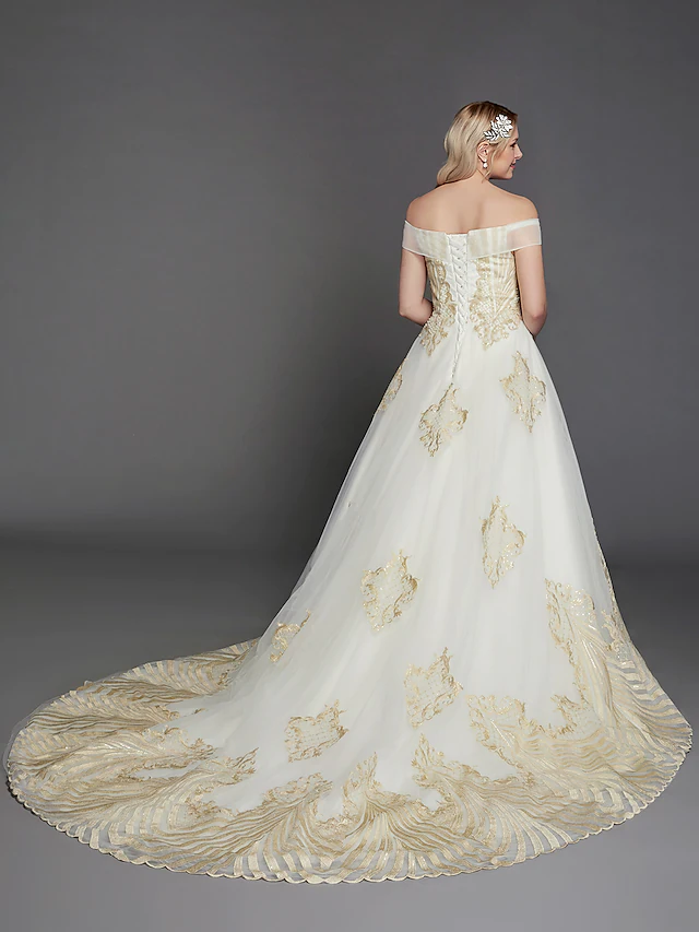 Back view of a princess off-shoulder wedding dress featuring a chapel train.