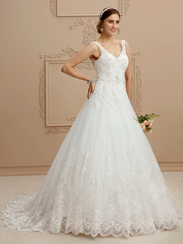 Close-up of V-neckline and intricate beaded lace on bodice.