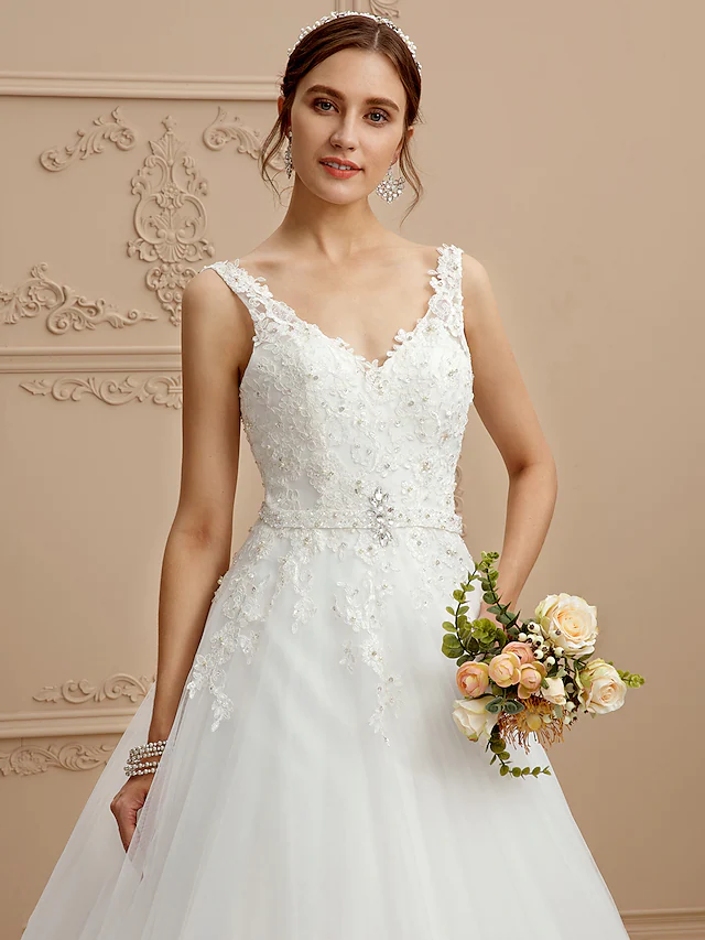 Detailed view of intricate lace appliques and beading.