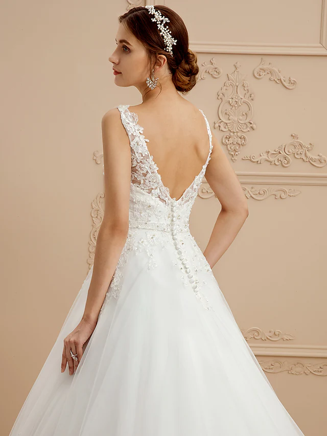 Full length view of wedding dress, highlighting flowing tulle skirt.