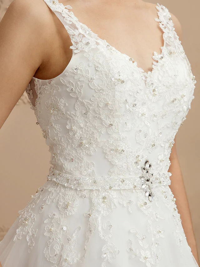 Back view of wedding dress, showing spaghetti straps and backless design.