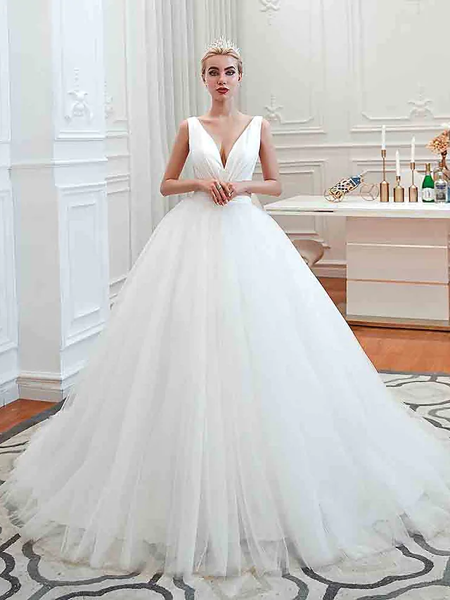 Full view of a glamorous V-neck ball gown wedding dress with ruched tulle.