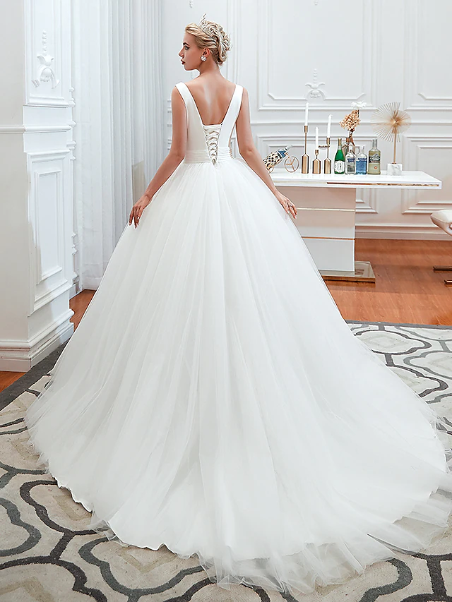 Close-up of the V-neckline and ruched bodice of the wedding dress.