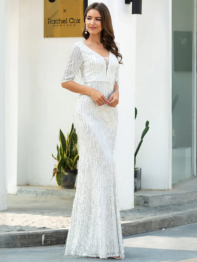 Close-up of the sequin tassel detail on the glittering gold evening gown.