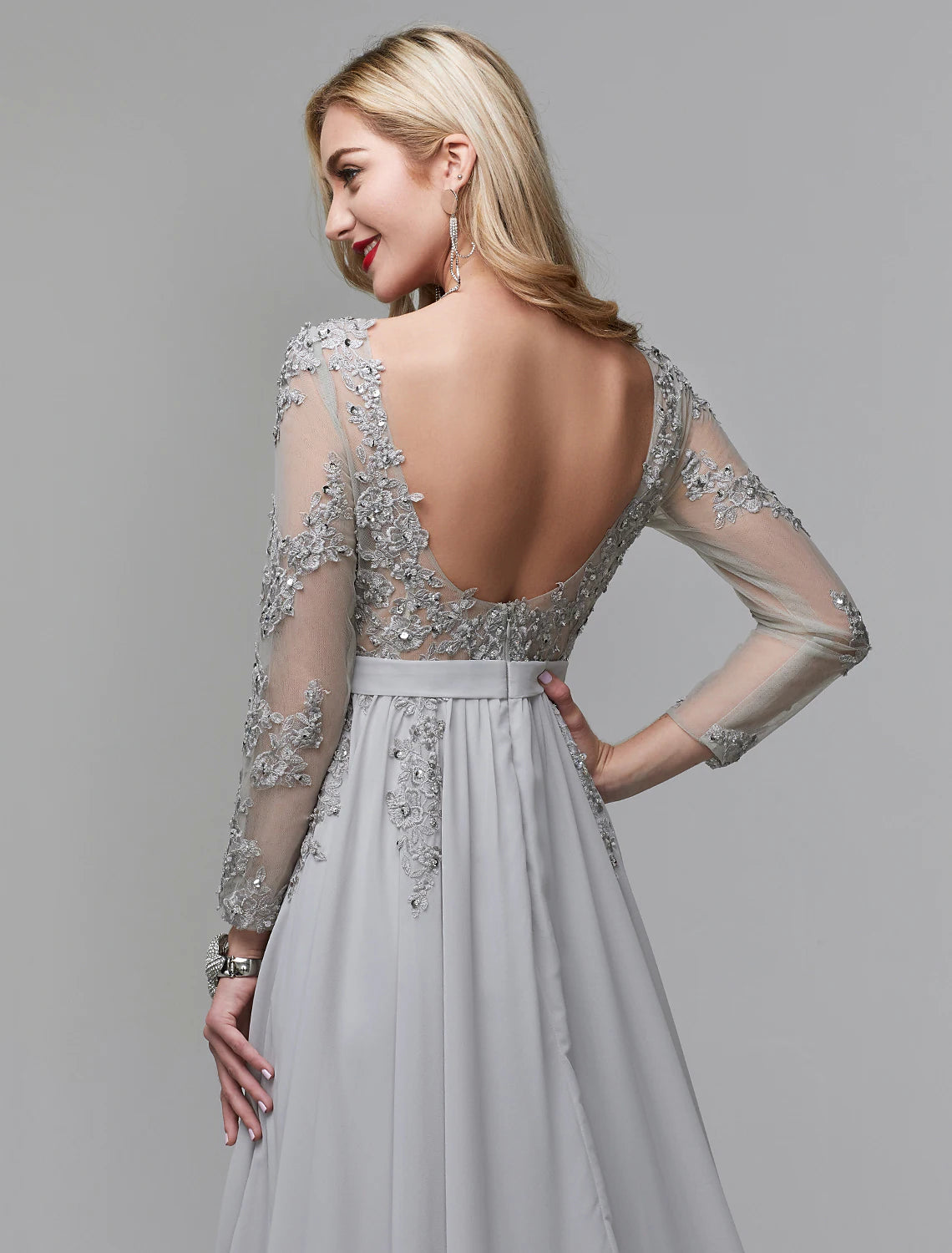 Back view of A-line formal gown featuring a V-back and chapel train.