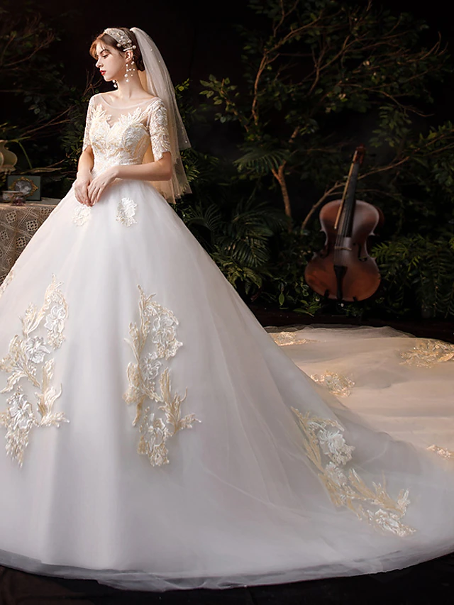 Side view of the elegant princess ball gown wedding dress, highlighting its full silhouette.