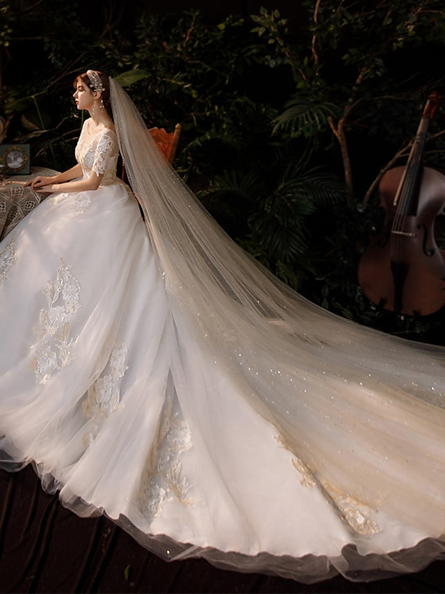 Full length view of the princess ball gown wedding dress, showcasing the flowing chapel train.