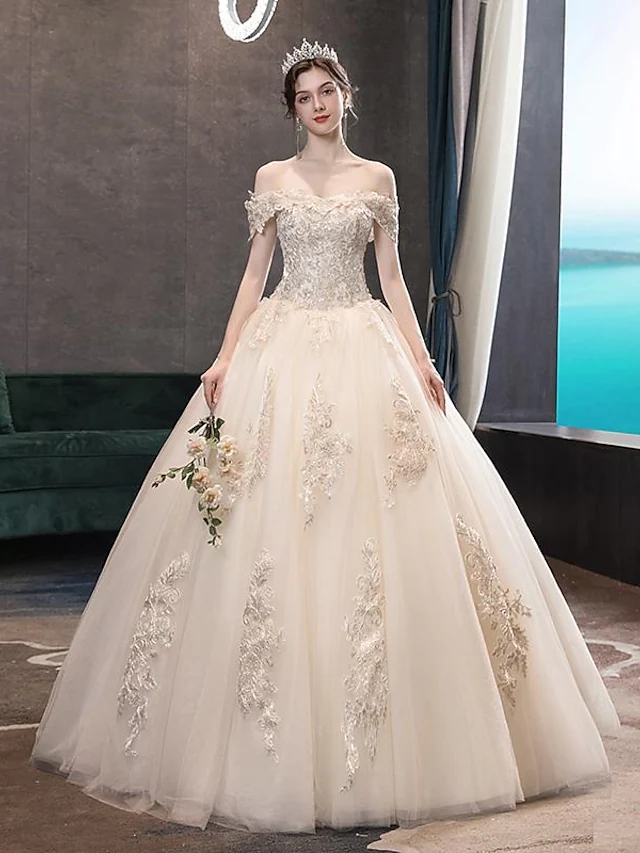 Elegant off-shoulder ball gown wedding dress.