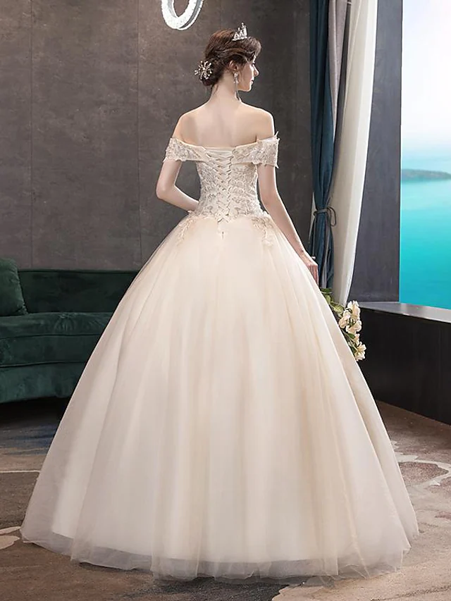 Close-up of lace and sequin details on wedding dress bodice.