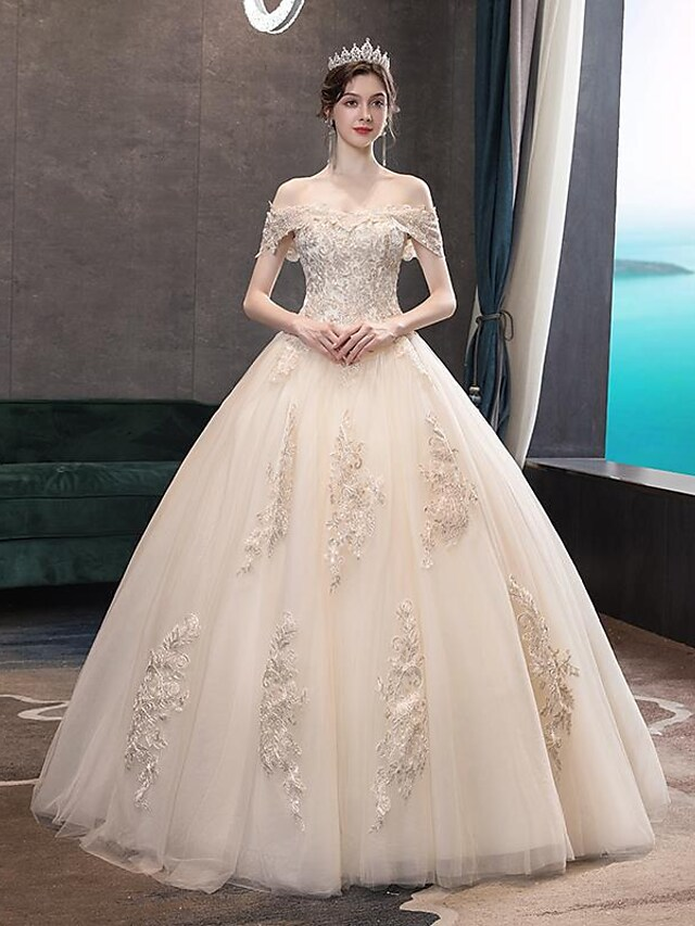 Side profile of bride wearing the off-shoulder bridal gown.
