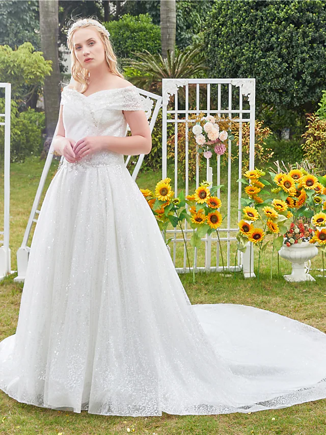 Elegant off shoulder ball gown wedding dress with lace and tulle.