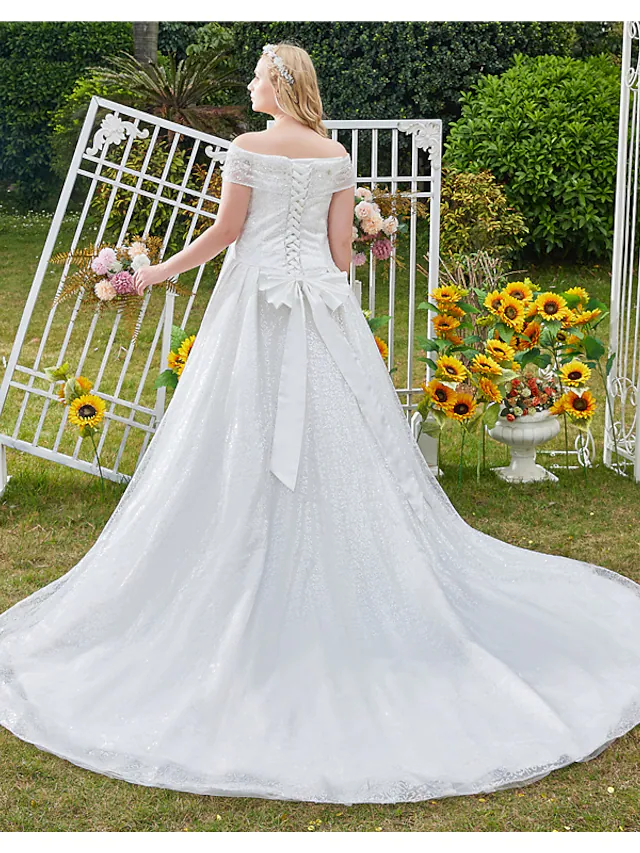 Side view of a luxurious off shoulder bridal ball gown.