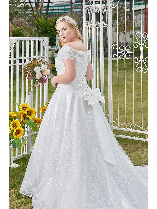 Elegant off shoulder wedding dress with a flowing tulle skirt.