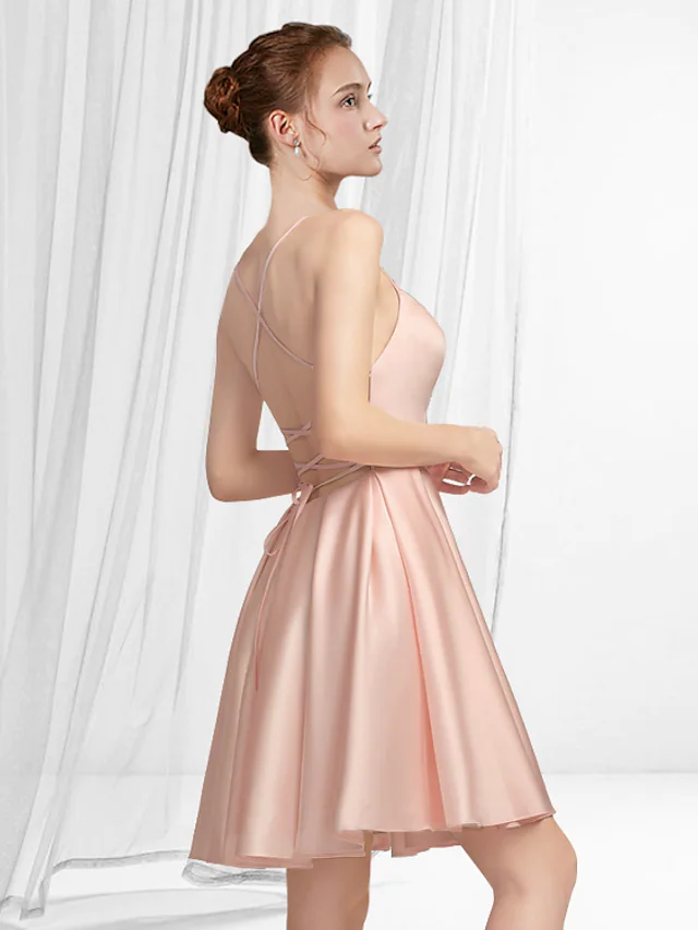 Back view of the A-line satin mini dress, showing pleats and sleeveless design.