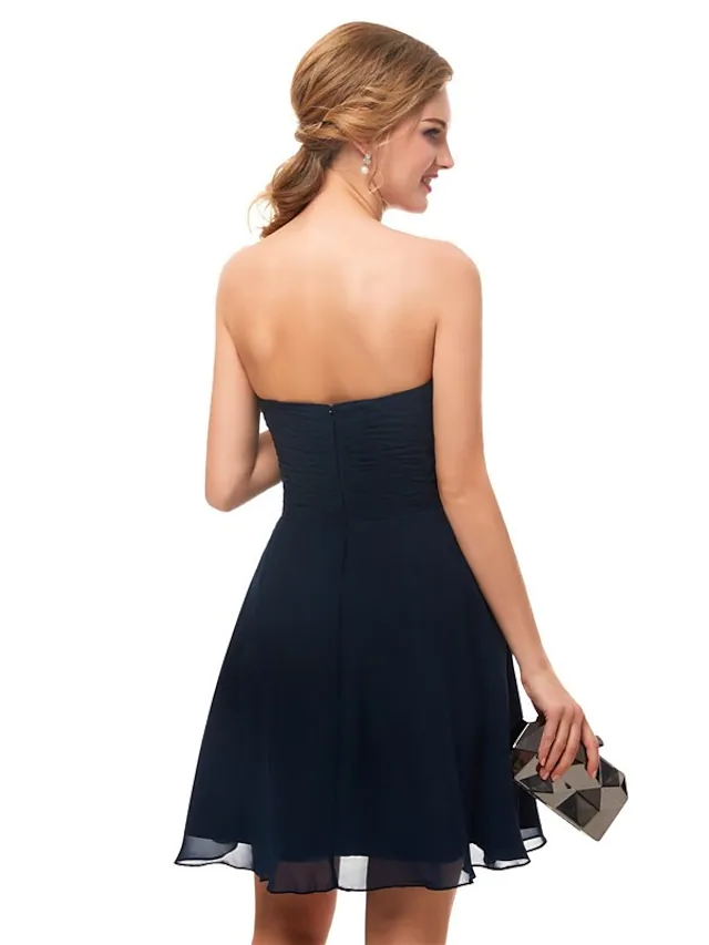 Side view of the minimalist strapless knee-length dress.