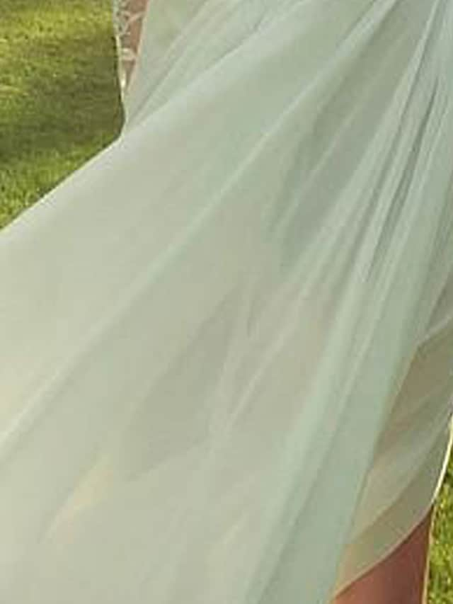 Detail of split front and lace appliques on the A-line wedding dress.