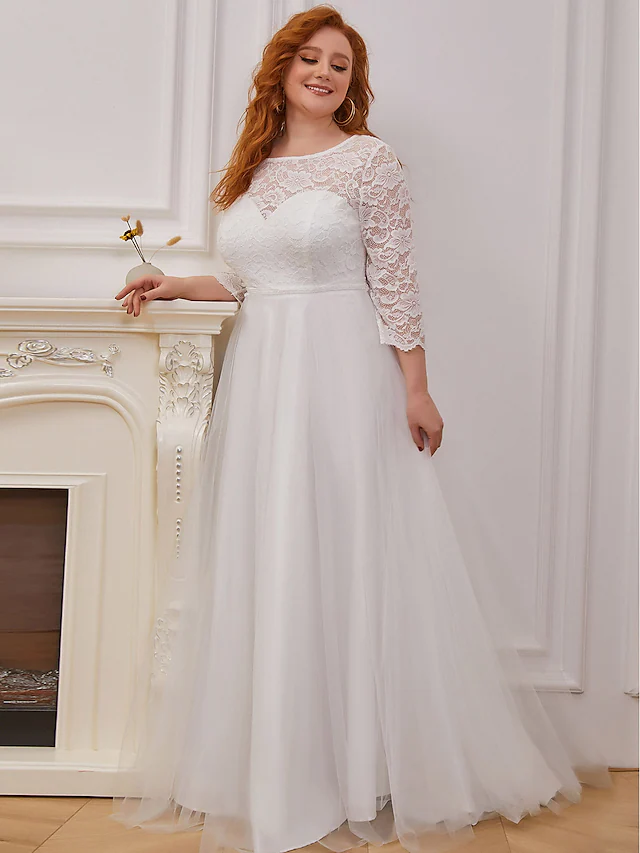 A-line wedding dress with jewel neck, lace bodice, and flowing tulle skirt with cascading ruffles.