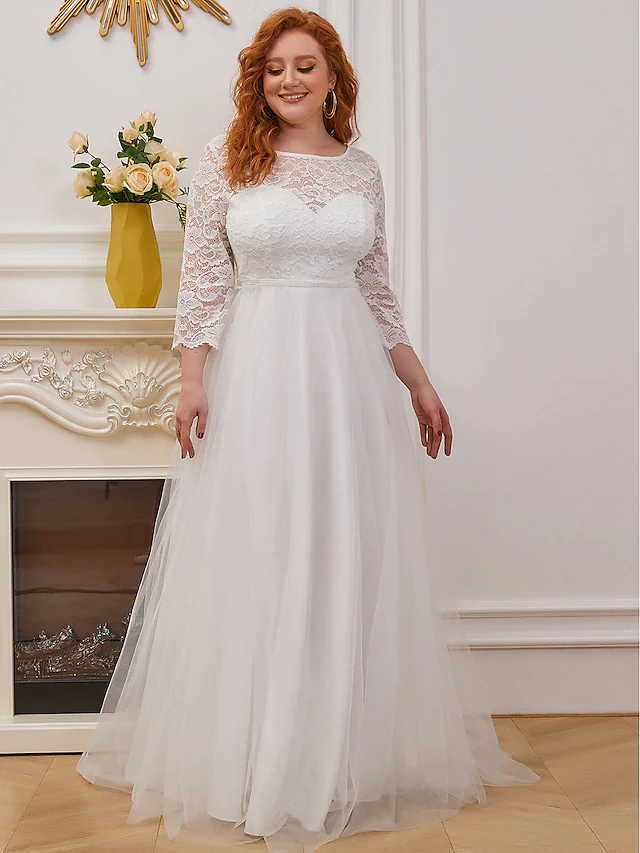 Full view of a sleeveless A-line wedding dress with a romantic lace and tulle design.