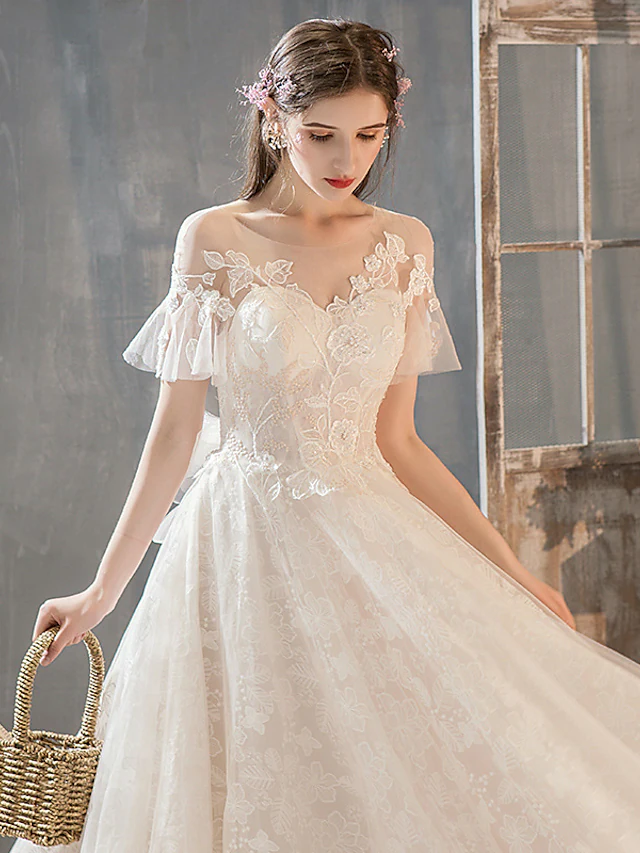 Full length view of romantic A-Line bridal gown with appliques.