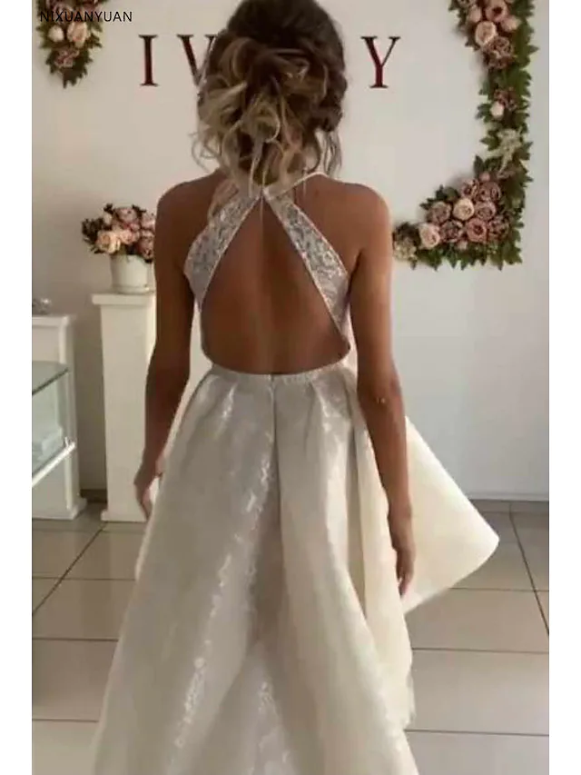 Side view of A-line wedding dress highlighting lace details and knee-length cut.