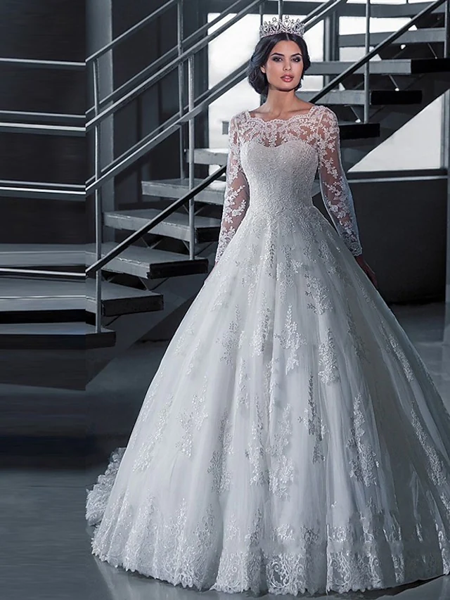 A-line off-shoulder wedding dress with lace and tulle, featuring long illusion sleeves and appliques.
