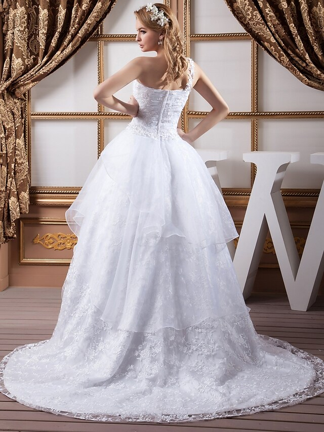 Side view of A-Line bridal dress highlighting ruched bodice and lace.
