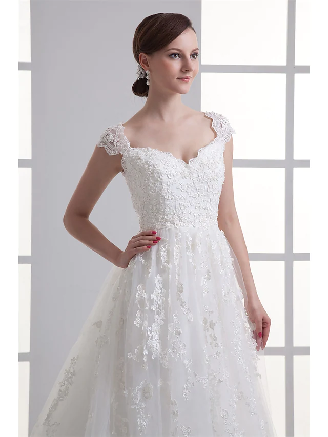 Side view of the bridal gown with A-line silhouette and cap sleeves.