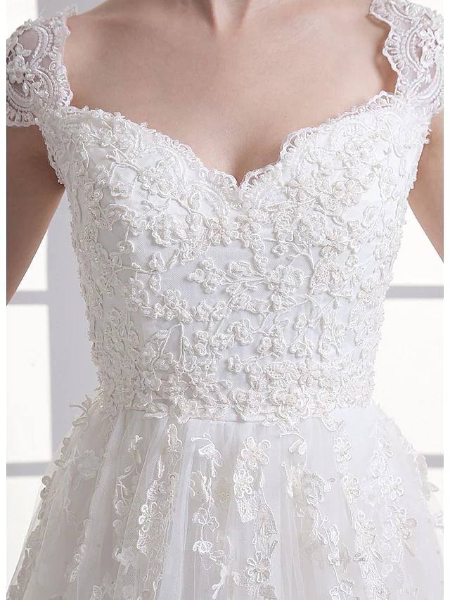 Detailed view of appliques and fabric on the wedding dress skirt.