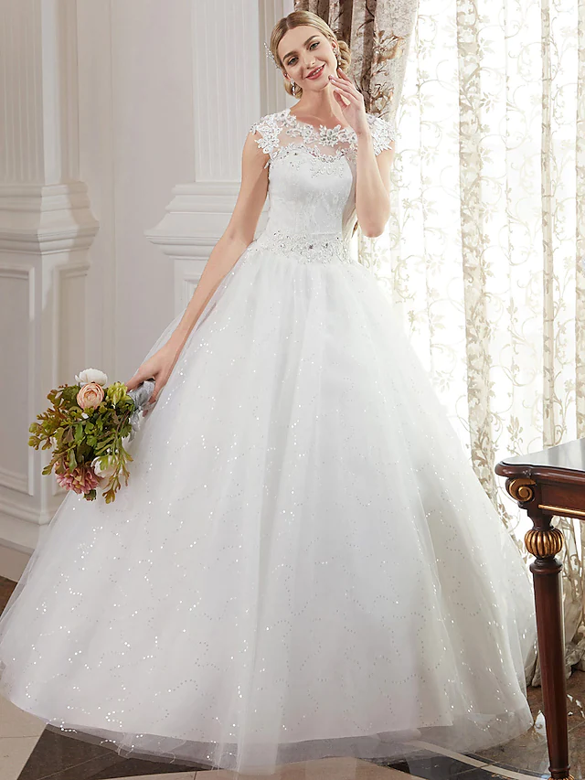 Front view of a romantic ball gown wedding dress with jewel neck and cap sleeves.