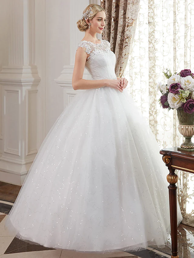 Close-up of the lace and beaded appliques on the wedding dress bodice.