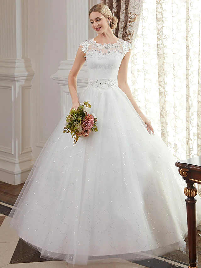 Side view of the floor-length tulle skirt and lace details of the bridal gown.