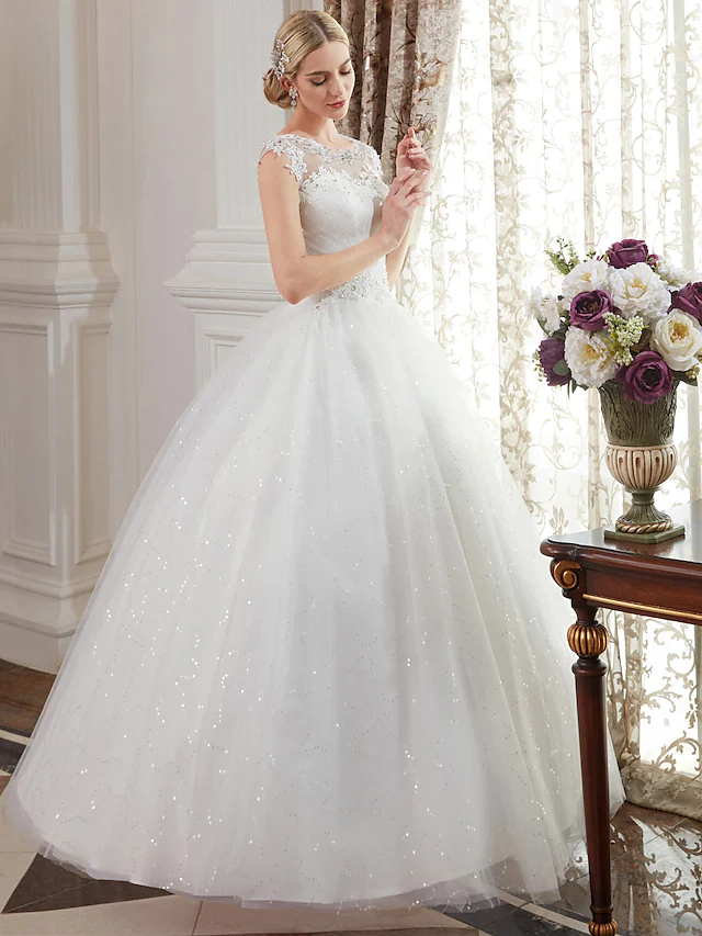 Back view of the elegant wedding dress showcasing illusion details.