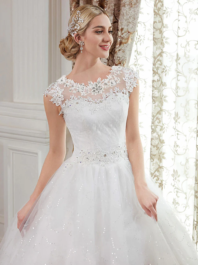 Detail of the cap sleeve and jewel neckline on the wedding dress.