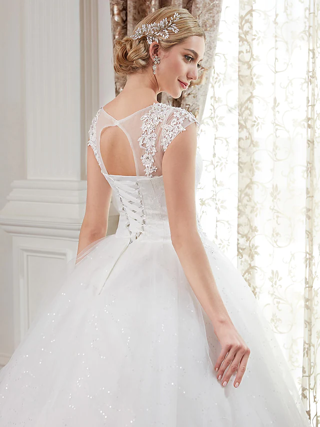 Full length view of the ball gown wedding dress with intricate lace.