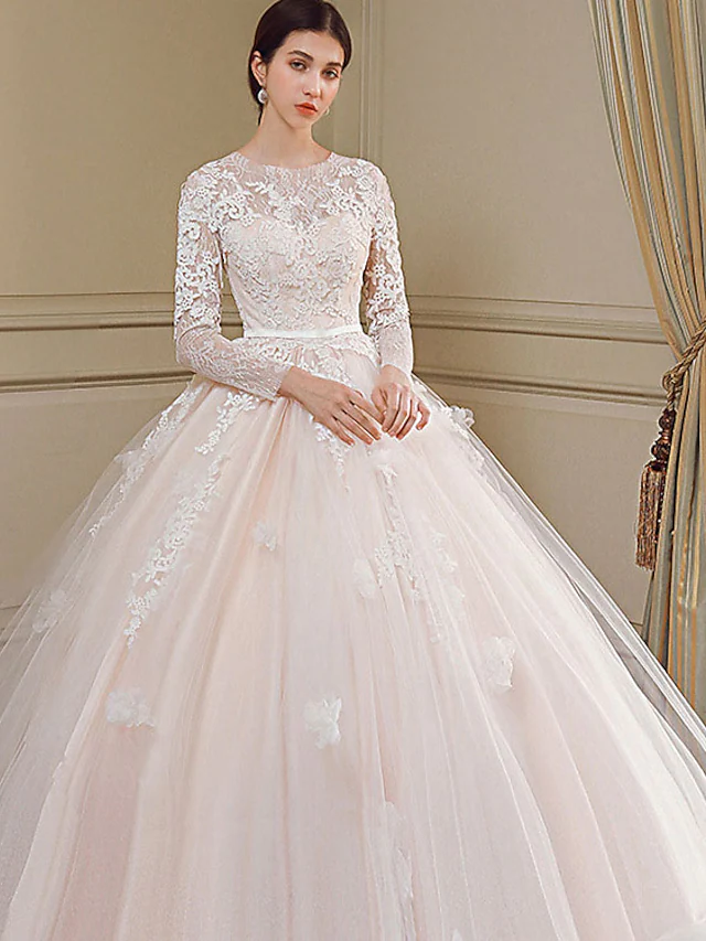 Back view of the wedding dress showcasing the chapel train and intricate appliques.