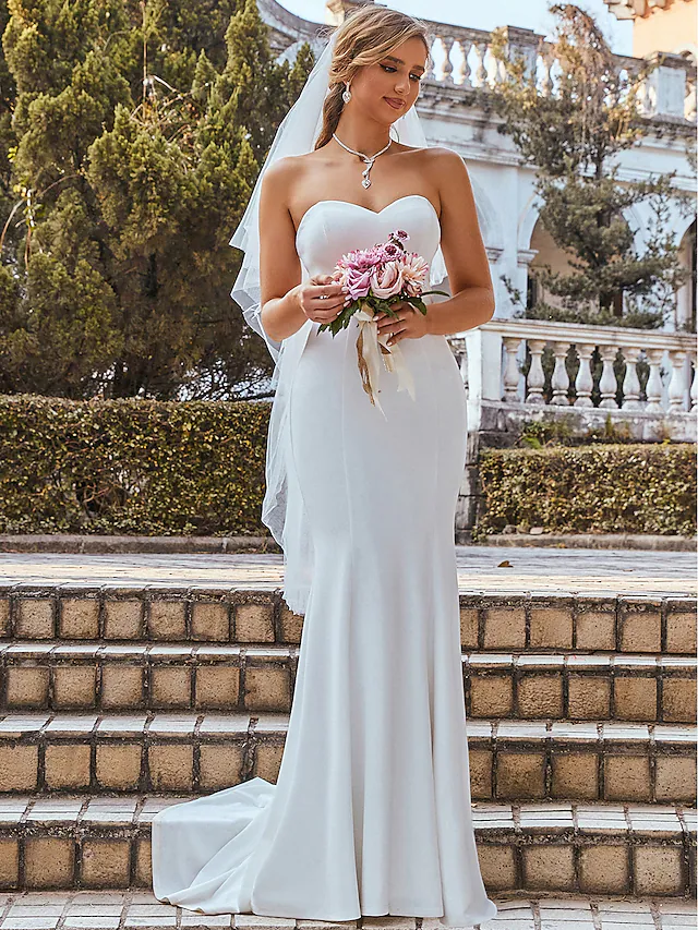 Sleeveless floor-length bridal gown, side view.