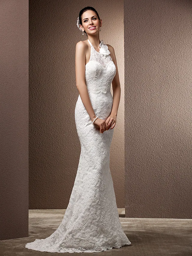 Close-up of the intricate lace and beading on the wedding dress.