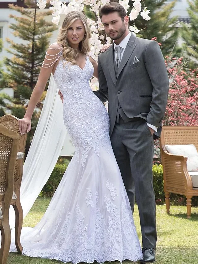 Elegant V-neck mermaid wedding dress with lace appliques and court train.